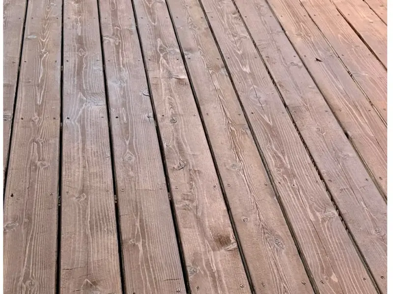 After: the same deck restored, stained, and sealed to a warm cedar tone
