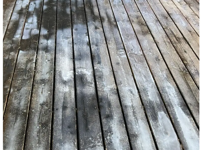 Before: gray, weathered deck boards with failing finish