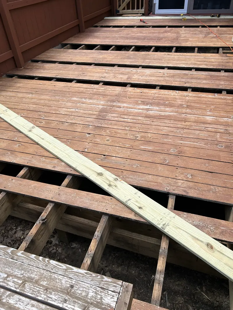 A replacement deck board fitted against the existing decking during repair